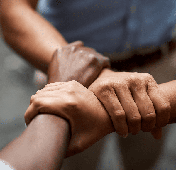 Hands joined in unity and support.
